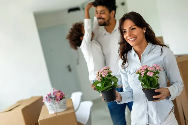 Parent child relocation love fun concept. Happy multiethnic family moving in new home